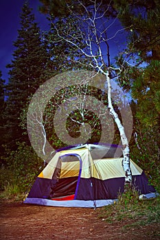 Camping tent in the forest at night