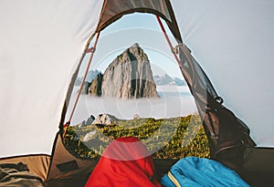 Camping tent mountain morning view travel couple in sleeping bags enjoying