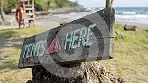 Camping tent sign by the beach