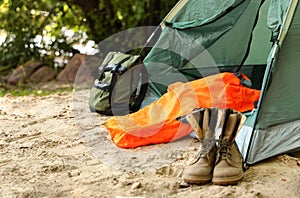 Camping tent with sleeping bag, boots and backpack