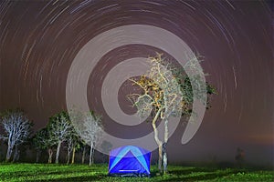 Camping in a Tent With Star Trails