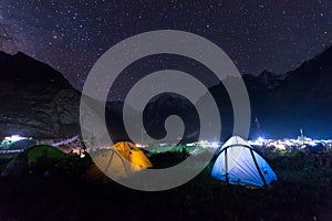 camping tent under milkyway with twinkling stars in the background