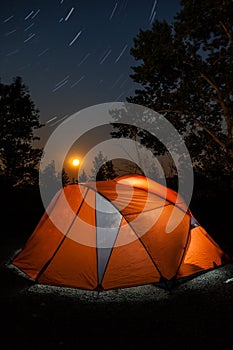 Camping Tent Under Star Trails and Rising Moon