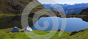 Camping tents on Lake Gentau, Pyrenees National Park.