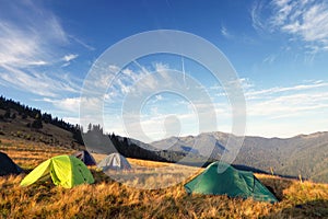 Camping tents on the meadow after sunrise