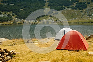 Camping tents near a mountain lake