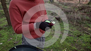 Camping, tourism and travel concept. Man setting up tent outdoors. Hiker assembles campsite tent in the autumnal forest