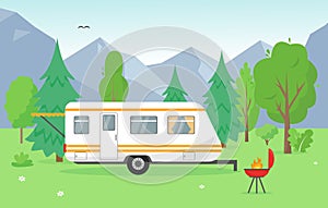 Camping trailer and barbecue near mountains