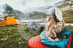 Camping travel vacations woman relaxing in sleeping bag on mat