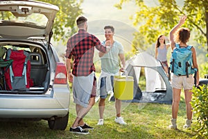 Camping trip, Young happy people say hello arrived friends