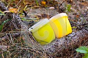 Camping utensils for picnic in the forest. Two mugs with lids for drinking tea and coffee on a hike