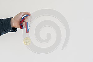 campion& x27;s hand holding a golden medal, simple winner lucky concept