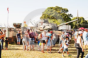 People visiting and taking photos of a war tank