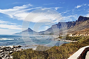 Camps Bay and Twelve Apostles against blue ocean and sky