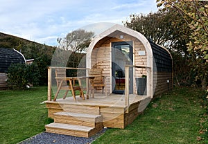 Campsite pods in a field.