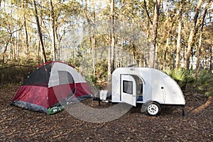 Campsite with teardrop trailer and tent