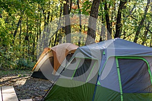 Campsite with two tents in early morning light in autumn