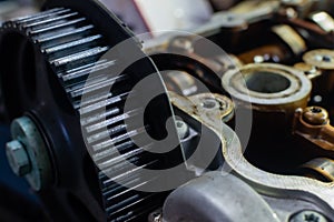 Camshaft gear of internal combustion engine on blurred background of disassembled engine photo
