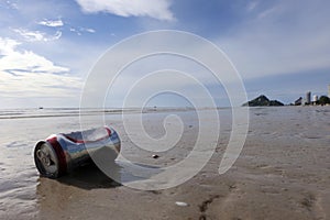 Can on a beach, environmental pollution concept.