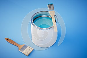 can of blue paint and brushes on blue background. 3d render