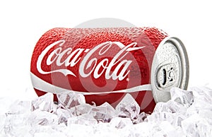 Can of Coca-Cola on a bed of ice over a white background