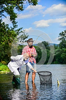 We can do it. Catching and fishing concept. Two male friends fishing together. fly fish hobby of businessman. retirement