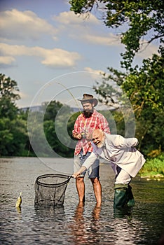 We can do it. Catching and fishing concept. Two male friends fishing together. fly fish hobby of businessman. retirement