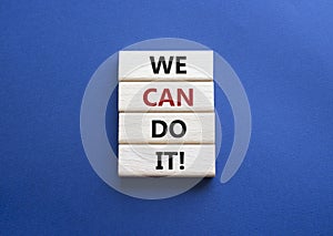 We can do it symbol. Concept words We can do it on wooden blocks. Beautiful deep blue background. Business and We can do it