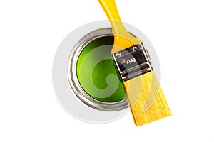 Can with green paint and brush isolated on white background top view