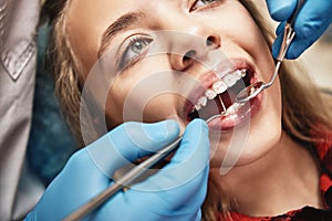 We can help you be at your best. Teen at the dental office. Dentist examining girl`s teeth in clinic.