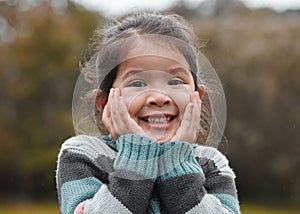 Can I go play now. an adorable little girl standing alone in the park and feeling excited.