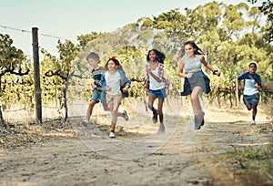 We can learn a lot from kids about living life. a group of teenagers running through nature at summer camp.