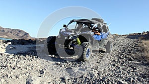Can-Am Maverick all-terrain vehicle ATV driving down an unpaved mountain road, La Paz, BCS, Mexico photo