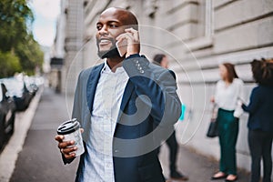We can meet up after my meeting later. a businessman using his cellphone while out in the city.