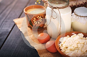 A can of milk and other farm products on the table. Still life in rural style.