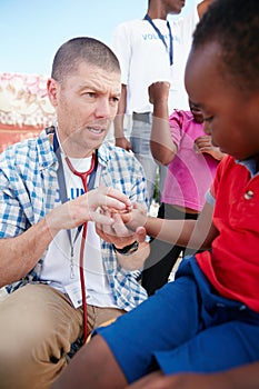 Can you feel this. a volunteer doctor giving checkups to underprivileged kids.