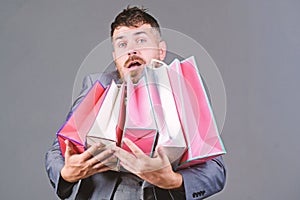 Can you imagine that. Telling friend about sales. bearded man in formal suit. stylish esthete with shopping bags