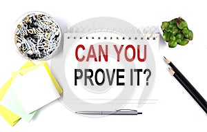 CAN YOU PROVE IT text on notebook with office supplies on white background