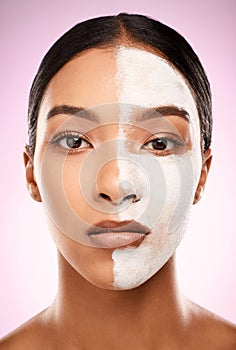 Can you see the difference. Studio shot of an attractive young woman having a facial against a pink background.