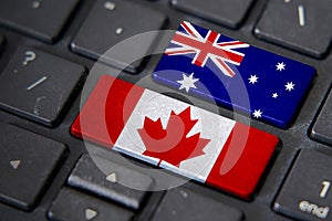Canada and Australia flags on computer keyboard