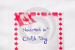 Canada Child Day handwriting on paper with Canada flag. Writing text on memo post reminder. Bucharest, Romania, 2020