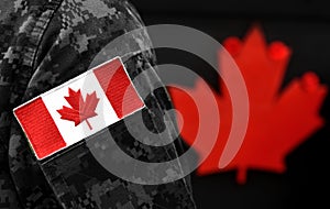 Canada Day. Flag of Canada on the military uniform and red Maple leaf on the background. Canadian soldiers. Army of Canada. Canada