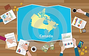 Canada economy country growth nation team discuss with fold maps view from top