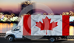 Canada flag on the side of a white van against the backdrop of a blurred city and river. Logistics concept