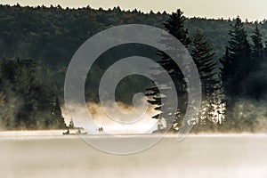 Canada Ontario Lake of two rivers Canoe Canoes foggy water sunrise fog golden hour on water in Algonquin National Park