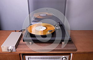 CANADA, Ontario - Nov 09, 2019: Vintage Stereo Turntable Plays Yellow Vinyl Record Album