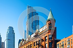Canada, Toronto. The famous Gooderham building and the skyscrapers in the background. View of the city in the day.