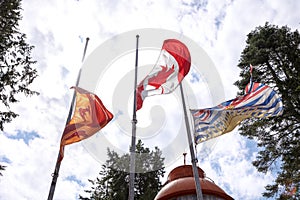 Canadian, British Columbia, and First Nations flag flying in Sooke on Canada Day.