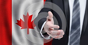 Canadian business, politics, cooperation and travel concept. Hand on flag of Canada background