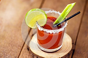 Canadian Caesar drink. Made with vodka, hot sauce and Worcestershire sauce, served with ice in a celery glass with a salted rim,